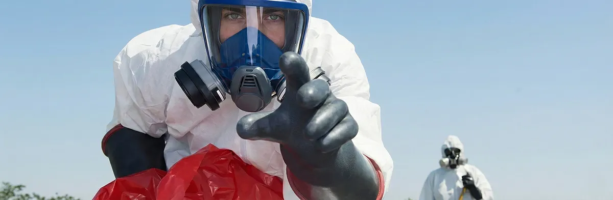 sewage clean up technician wearing protective gear handling biohazard materials in Cleveland, OH