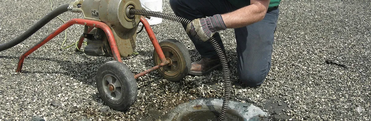 sewer rodding technician actively removing blockages from a sewer line in Cleveland, OH